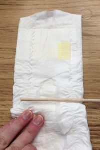 place dowel in fold of diaper