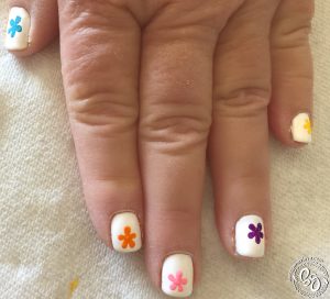 I began by painting a different color, whole flower on each finger; This was to guarantee that each color had at least one whole flower.
